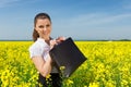 Girl with briefcase on yellow flower field Royalty Free Stock Photo