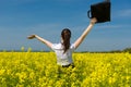 Girl with briefcase on yellow flower field Royalty Free Stock Photo