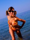 A girl in a bright bathing suit and dark glasses a