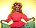 Girl with bright makeup and hair balls on yellow background