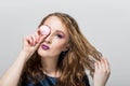 Girl with bright professional make-up closed one eye pink marshmallows Royalty Free Stock Photo