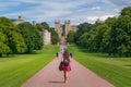 Girl in Bright Red Dress Walking down Long Walk Royalty Free Stock Photo