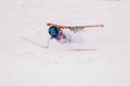 Girl in bright suit beautifully falls on skis