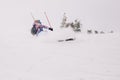 Girl in bright suit beautifully falls on skis