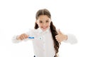 Girl brilliant perfect smile holds toothbrush with drop of paste white background. Child holds toothbrush and shows