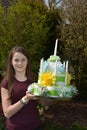 Girl brings birthday cake made of toilet paper Royalty Free Stock Photo