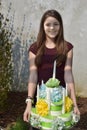 Girl brings birthday cake made of toilet paper Royalty Free Stock Photo