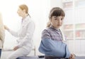 Girl with broken arm and arm brace in the doctor`s office