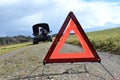 Girl, broken car and triangle Royalty Free Stock Photo