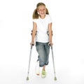 Girl with a broken leg walking on crutches Royalty Free Stock Photo