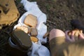 Girl with brown bread in uniform with a military flask