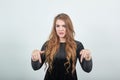 Girl brown haired in black dress over isolated white background shows emotions Royalty Free Stock Photo