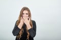 Girl brown haired in black dress over isolated white background shows emotions Royalty Free Stock Photo