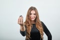 Girl brown haired in black dress over isolated white background shows emotions Royalty Free Stock Photo