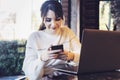 Girl browsing social networks on smartphone while sitting cafe. Blogger chatting with followers oncell phone coffee shop.Lifestyle Royalty Free Stock Photo