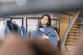 The girl in the clothing store chooses a denim jacket, chose and pressed to her. Royalty Free Stock Photo