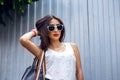 Girl brunette in a park in the summer resting white blouse on the background of wooden fence, fashion lifestyle, gentle Royalty Free Stock Photo