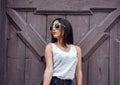 Girl brunette in a park in the summer resting white blouse on the background of wooden fence, fashion lifestyle, gentle Royalty Free Stock Photo