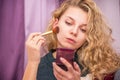 Girl doing makeup on her face Royalty Free Stock Photo