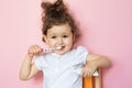 Girl brushes her teeth with toothpaste.