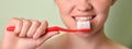 Girl brushing her teeth closeup, dental care concept