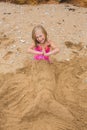 Girl build from the sand on the beach Royalty Free Stock Photo
