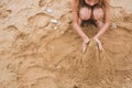 Girl build from the sand on the beach Royalty Free Stock Photo