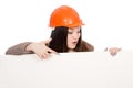 Girl builder in helmet showing a finger on a blank banner.