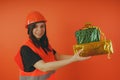 Girl Builder with presents in hand, the concept of cashback, gift with purchase or discount.