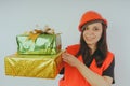Girl Builder with presents in hand, the concept of cashback, gift with purchase or discount.
