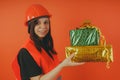 Girl Builder with presents in hand, the concept of cashback, gift with purchase or discount.