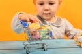 A girl with bunny ears puts dyed Easter eggs in a cart and deliv Royalty Free Stock Photo