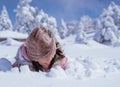 girl burried half of her body while playing outside in the snow