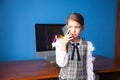 girl in a business suit stands at the computer and talks on the phone Royalty Free Stock Photo