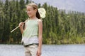 Girl With Butterfly Net Standing By Lake Royalty Free Stock Photo