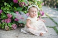 girl with butterfly wings in hydrangea park Royalty Free Stock Photo