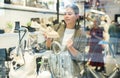 Girl buyer looks at footwear from new collection and picks up new pair of moccasins shoes