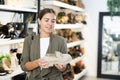 Girl buyer looks at footwear from new collection and picks up new pair of moccasins shoes