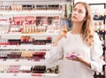 Girl buying perfume in makeup store