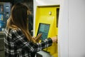 The girl buys a ticket on the subway in a special ticket machine Royalty Free Stock Photo