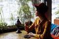 Girl in a cafe with a cup of coffee and a hat.portrait of sensual young girl wearing floppy hat and blouse with bow. Beautiful Royalty Free Stock Photo