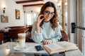 Girl in cafe reading funny book