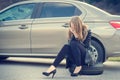 Girl calling. Broken car on a background. Woman sit on a wheel. young woman repair a car. Natural background. Car accide Royalty Free Stock Photo