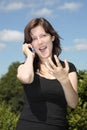 Girl calling by cell phone gesturing w hand Royalty Free Stock Photo