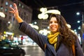 Girl calling taxi in urban environment Royalty Free Stock Photo