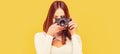 Girl with a cameras. Woman holding camera over yellow background. Girl using a camera photo Royalty Free Stock Photo