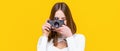Girl with a cameras. Woman holding camera over yellow background. Girl using a camera photo. Photographer camera photo Royalty Free Stock Photo