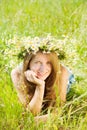 Girl in camomiles chaplet in grass Royalty Free Stock Photo