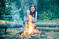 Girl camping with marshmallows over a camp fire. Girl enjoying picnic in the forest. Vacation weekend picnic camping and Royalty Free Stock Photo