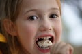 Girl in the campsite, eating porridge, having fun in the outdoors Royalty Free Stock Photo